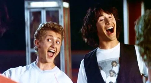 Bill and Ted, two young men, playing air guitar enthusiastically