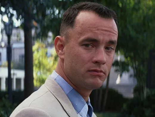 Forrest Gump sitting on a bench with a box of chocolates