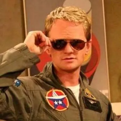 Barney Stinson in a suit and sunglasses, posing confidently