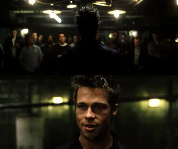Brad Pitt as Tyler Durden standing under a lamp in a basement, addressing a crowd