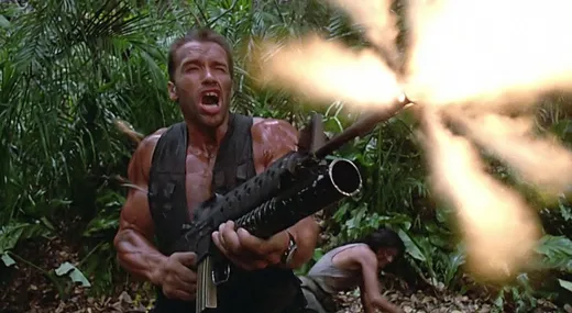Arnold Schwarzenegger in the jungle, muddy and shouting