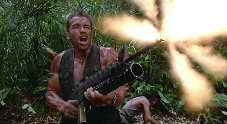 Arnold Schwarzenegger in the jungle, muddy and shouting