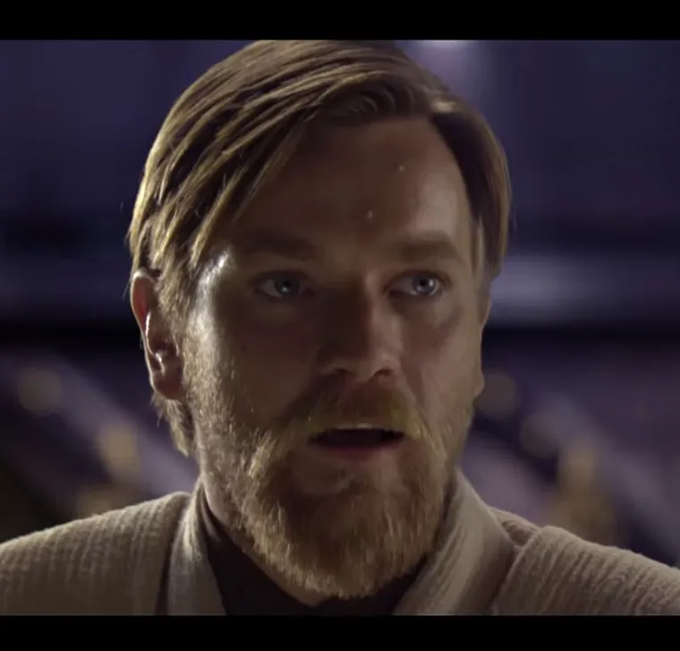 Obi-Wan Kenobi with a beard and a calm, slight smile