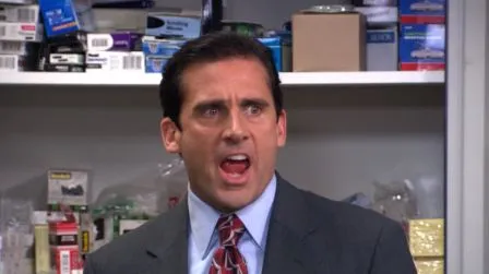 Michael Scott standing in the office, shouting with his arms out