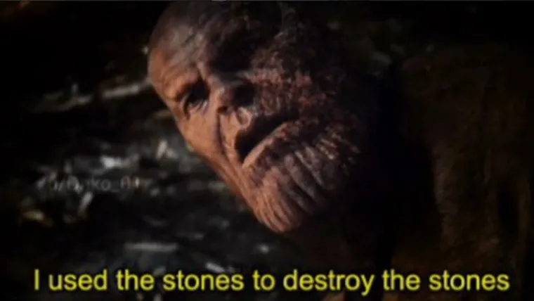 Thanos, wounded and tired, speaking in a dim hut, with subtitles