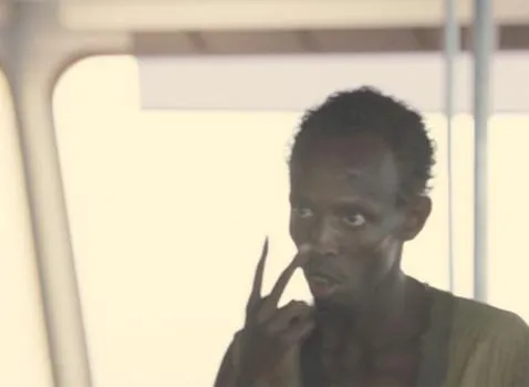 Barkhad Abdi as the pirate Muse, close up, staring intently
