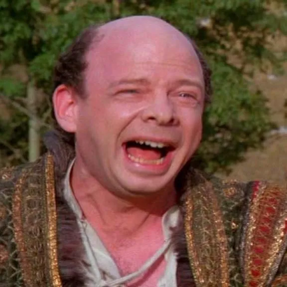 Vizzini, a short balding man, shouting with his mouth wide open