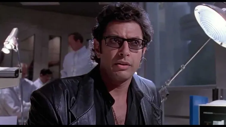Jeff Goldblum in a black leather jacket and sunglasses, talking