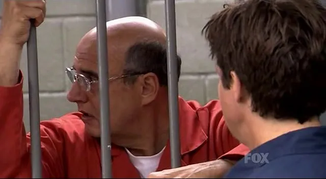 George Bluth Sr. in a prison visiting room talking to his son Michael