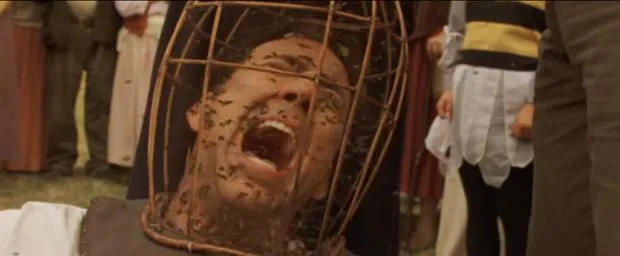 Nicolas Cage screaming with his head inside a wire mesh helmet full of bees