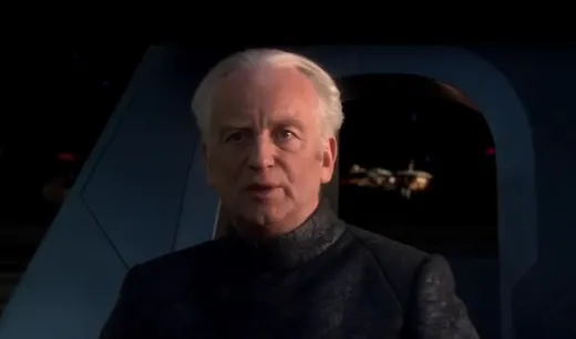 Chancellor Palpatine in a dark robe, looking up with a serious expression