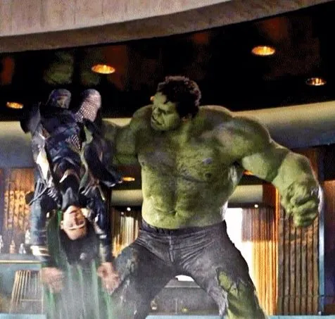 The Hulk standing over Loki, who lies in a crater in the floor