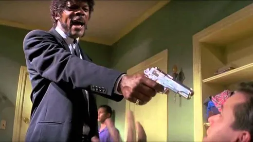 Samuel L. Jackson as Jules pointing a gun, looking furious