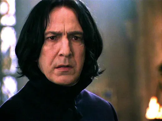 Severus Snape with long black hair, looking solemn