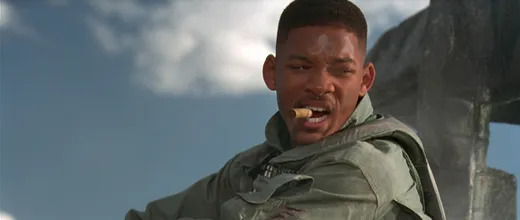 Will Smith in a flight suit in the desert, looking tough