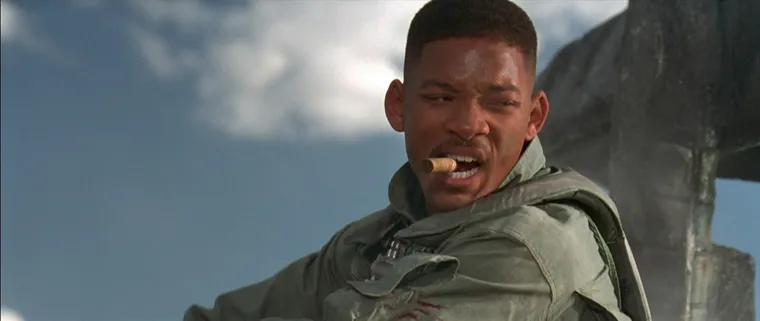 Will Smith in a flight suit in the desert, looking tough