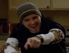 Jesse Pinkman in a beanie and gloves, cheering with his fists raised