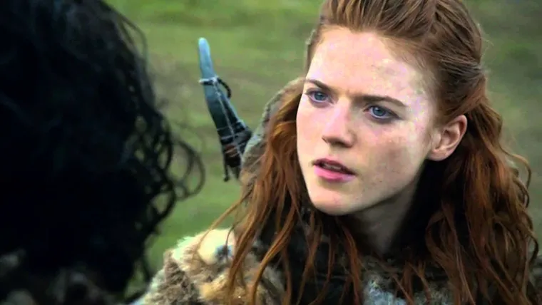 Ygritte, a red-haired wildling woman in furs, smiling in the snow
