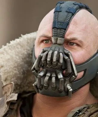 Bane in his breathing mask and fur-lined coat, looking down