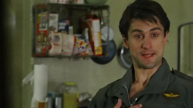 Robert De Niro in a military jacket, staring intensely
