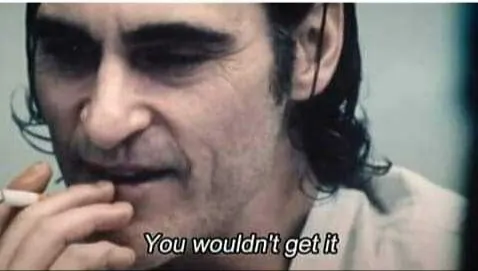 Joaquin Phoenix as Arthur Fleck, with smudged clown make-up and a cigarette, speaking